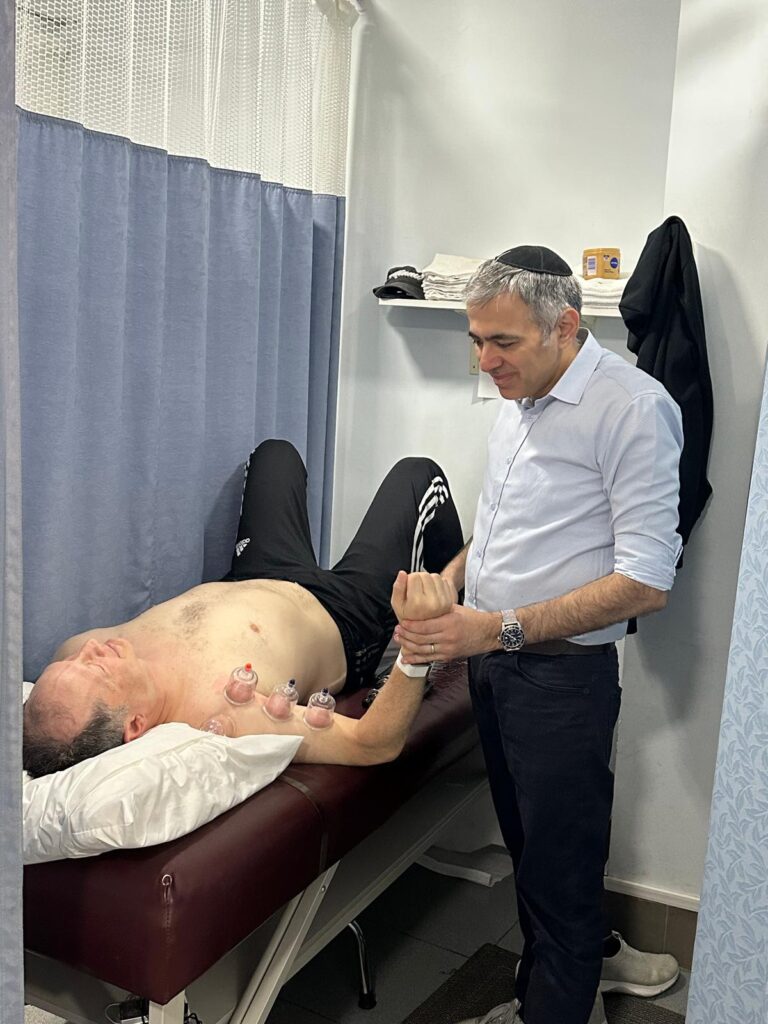 patient performing back strengthening exercises under therapist supervision