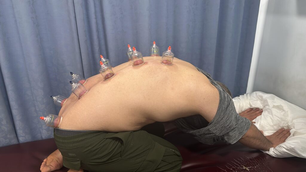 therapist helping patient with lower back pain therapy exercises